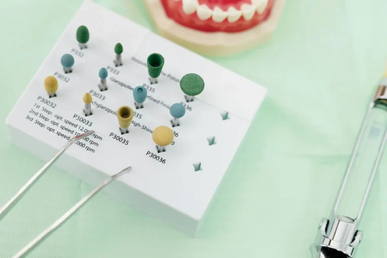 Close-up shot of stainless-steel dental instruments arranged on a sterile blue tray